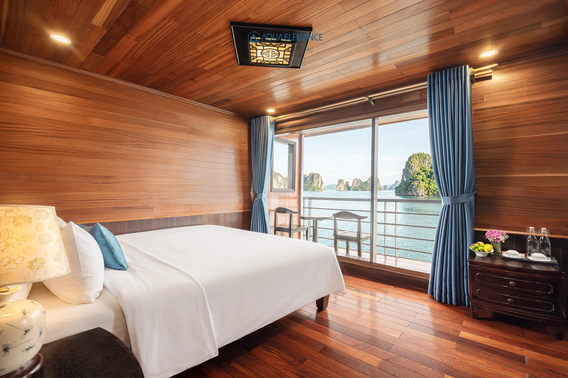 Senior Suite Balcony cabin with double bed and glass doors to the balcony on Aqua Elegance Cruise