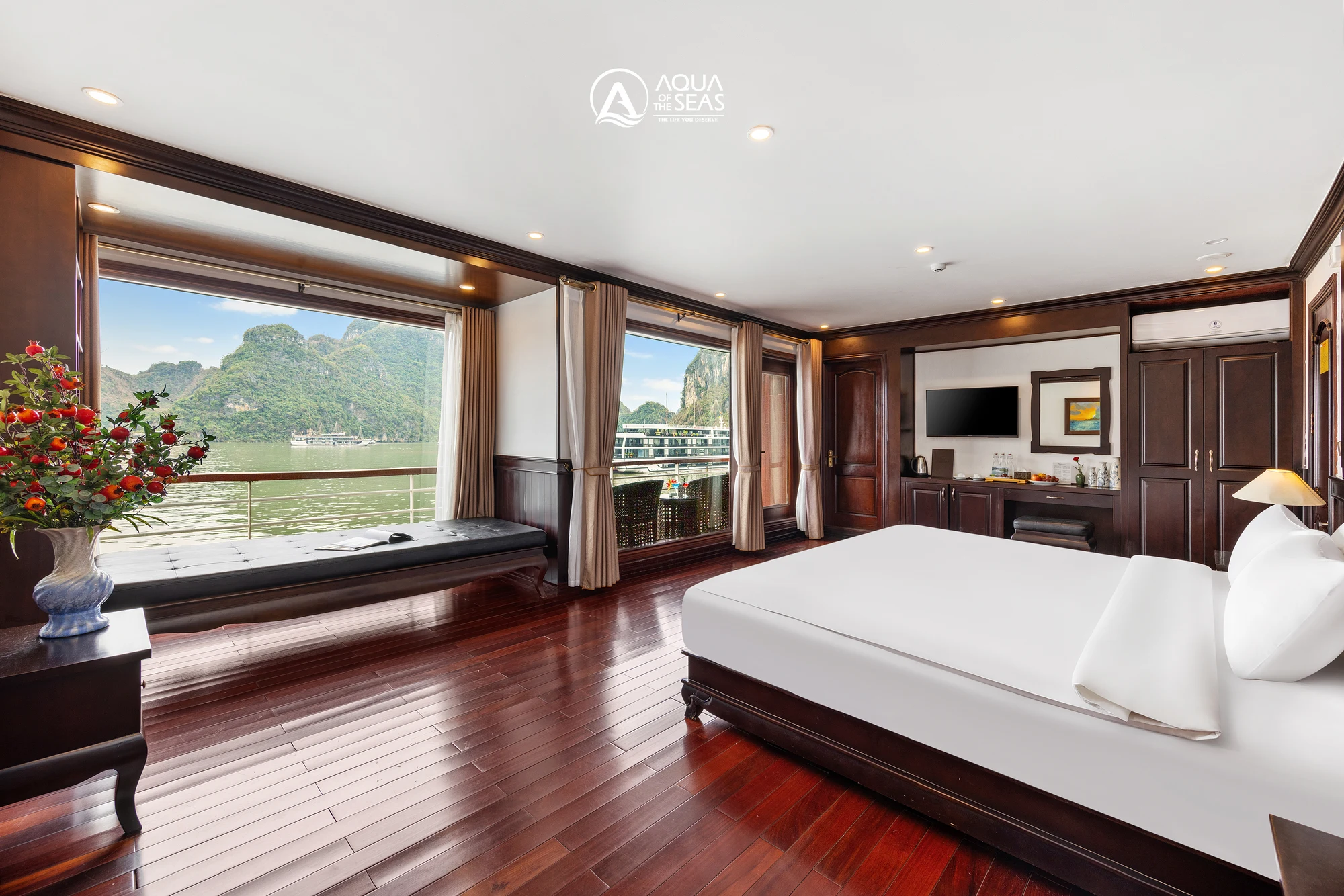 Royal Suite Balcony cabin with a double bed and wide bay-view windows on Aqua Of The Seas Cruise